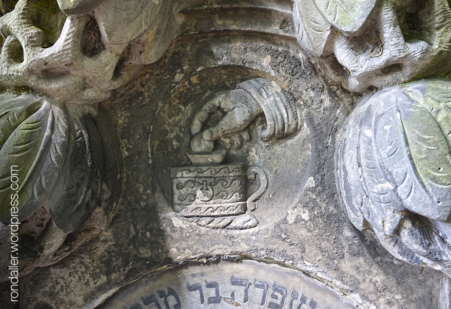 Símbols al cementiri jueu de Varsòvia. Relleu d'una ma introduint una moneda en una guardiola.