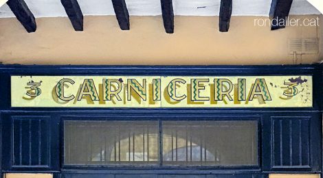 Rètol de vidre pintat en una carnisseria del carrer Prat de la Riba de Castelló d’Empúries.