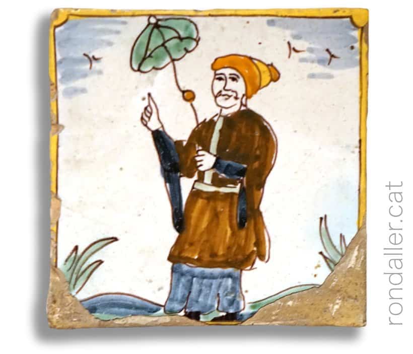 Rajoles d'oficis amb motius orientals. Representació d'una dona oriental amb un paraigua.