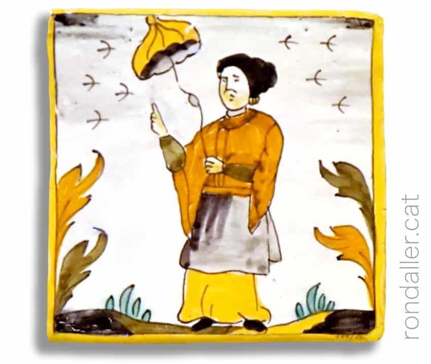 Rajoles d'oficis amb motius orientals. Dona amb una paraigua.